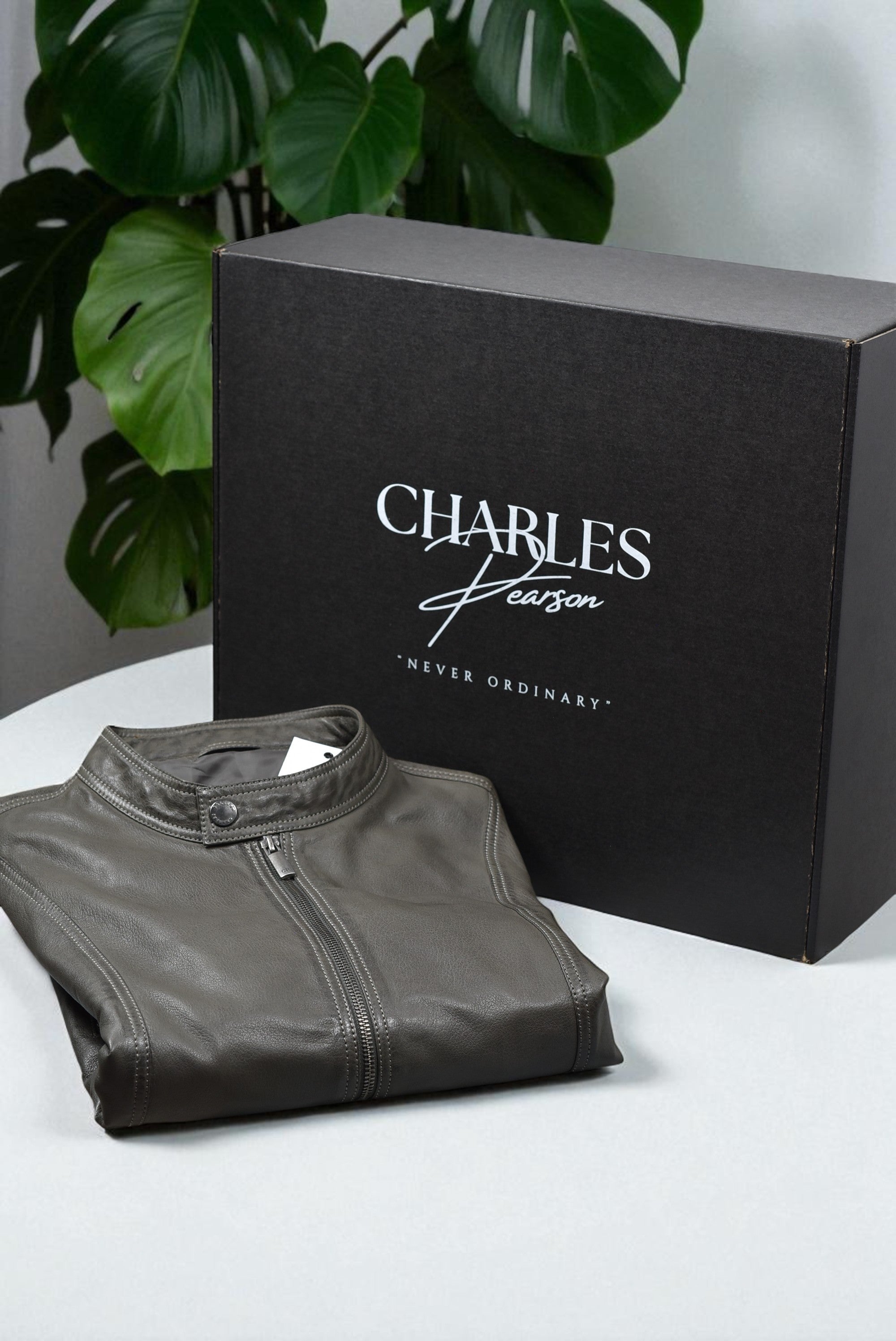 Gray leather jacket for men with 'Charles Person' branded box.