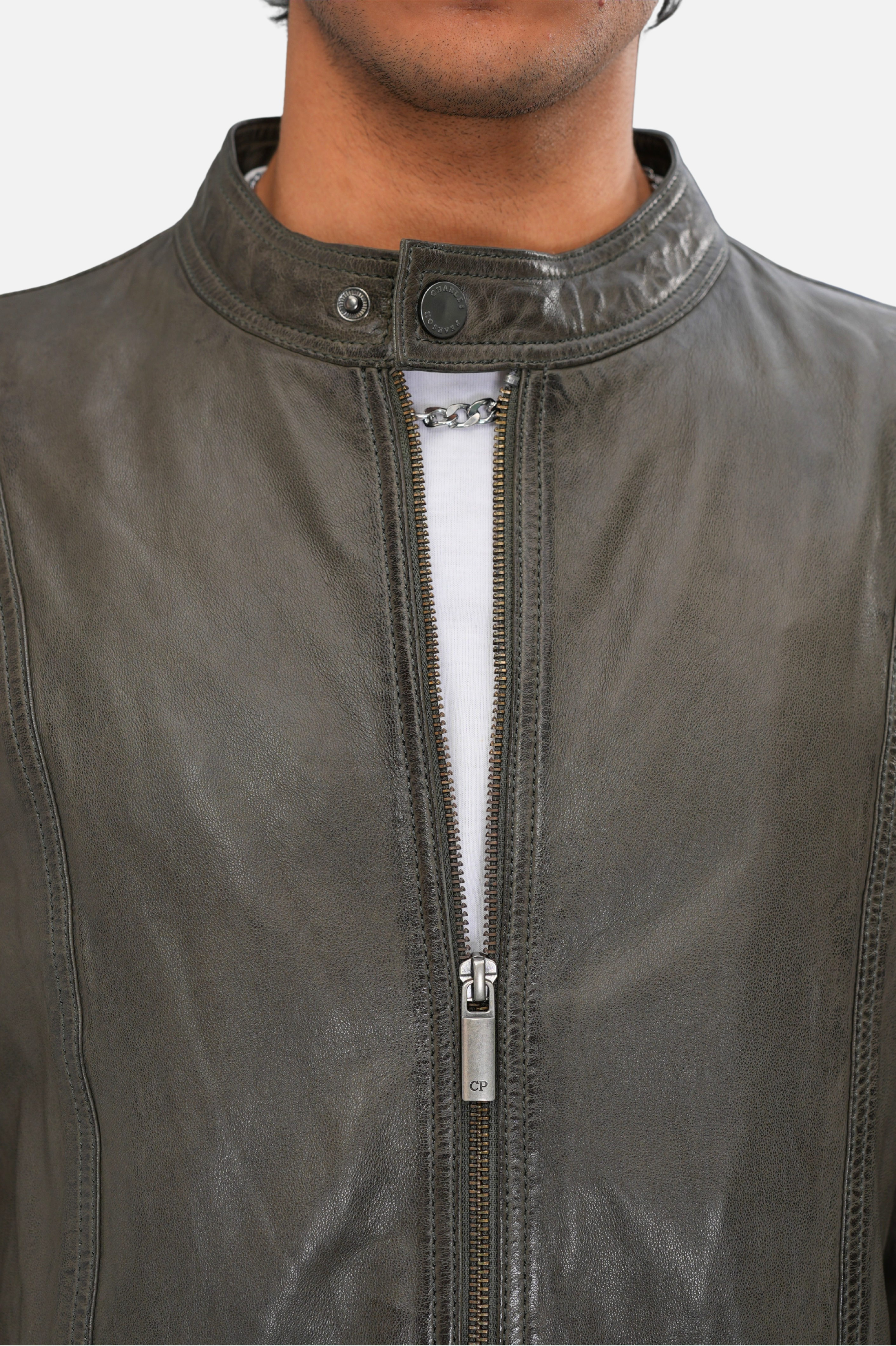 Close-up of a gray leather jacket with a zipper